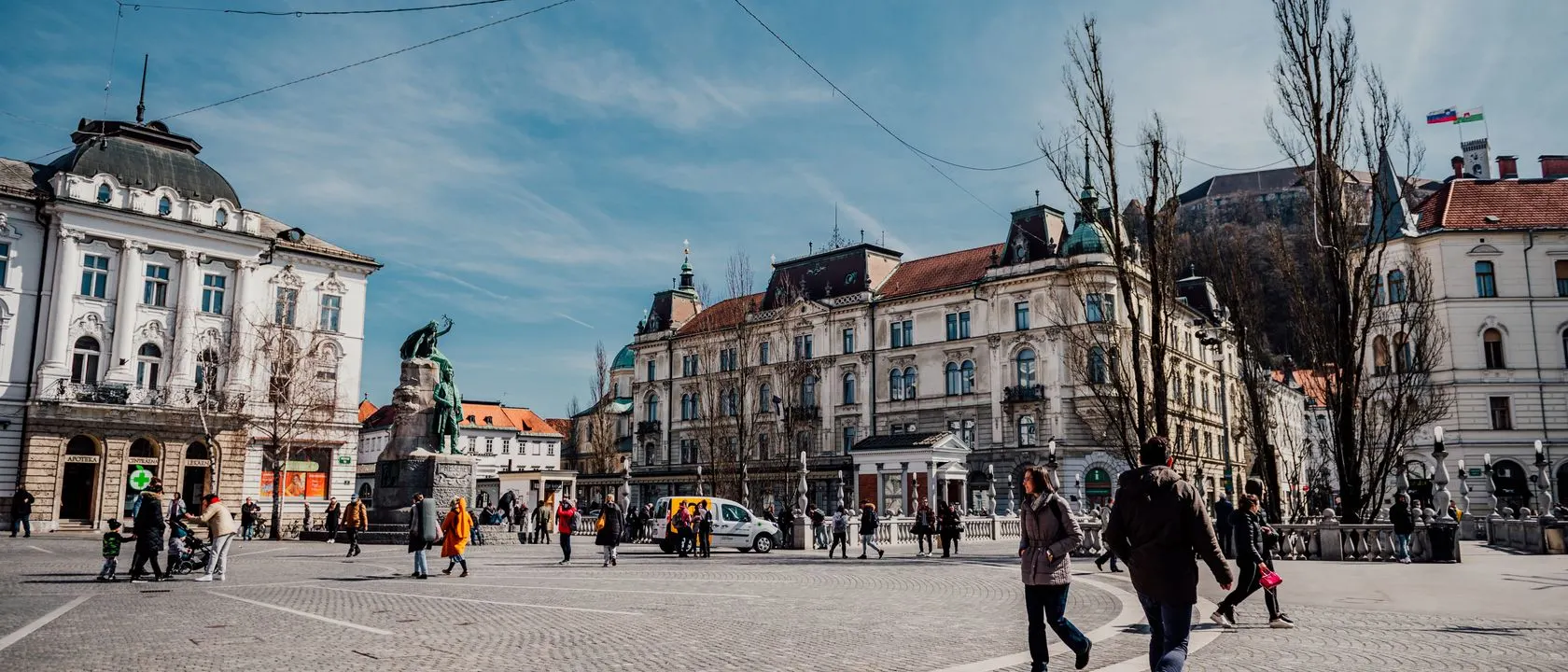 People on a lively European city square on a sunny day